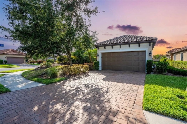 4704 Stafford Ct, Palmetto, FL 34221 - view of front of property with driveway, stucco siding, a garage, and a front yard