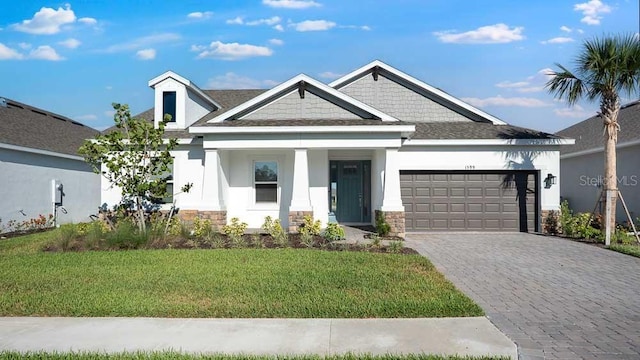 1599 Laurel Brook Ln, Port Charlotte, FL 33953 - view of front of property with stone siding, an attached garage, stucco siding, and a front yard