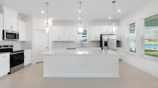 1599 Laurel Brook Ln, Port Charlotte, FL 33953 - kitchen featuring stainless steel appliances, a sink, a center island, crown molding, and backsplash