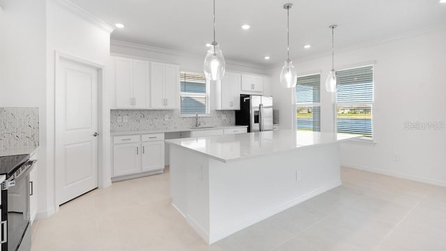 1599 Laurel Brook Ln, Port Charlotte, FL 33953 - kitchen with stainless steel appliances, crown molding, a sink, decorative backsplash, and a center island