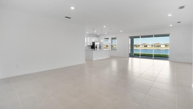 1599 Laurel Brook Ln, Port Charlotte, FL 33953 - unfurnished living room with recessed lighting and light tile patterned floors