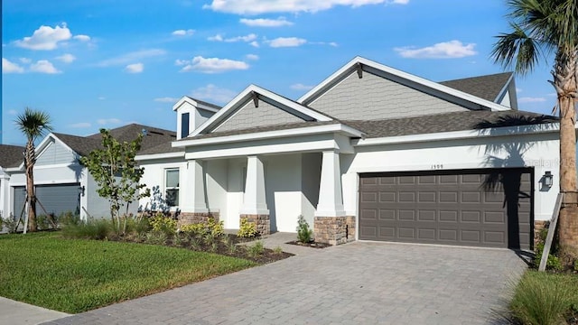 1599 Laurel Brook Ln, Port Charlotte, FL 33953 - view of front of home featuring stucco siding, stone siding, an attached garage, and a shingled roof