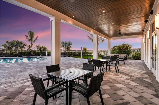 1599 Laurel Brook Ln, Port Charlotte, FL 33953 - patio terrace at dusk with outdoor dining area, a patio area, ceiling fan, and an outdoor living space