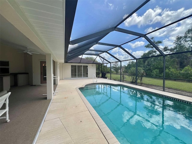 outdoor pool featuring ceiling fan, a lanai, and a patio