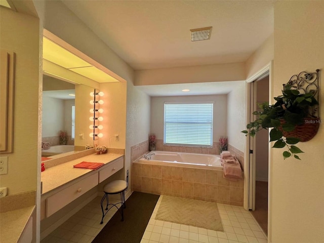 full bathroom featuring tile patterned floors, vanity, a garden tub, and visible vents
