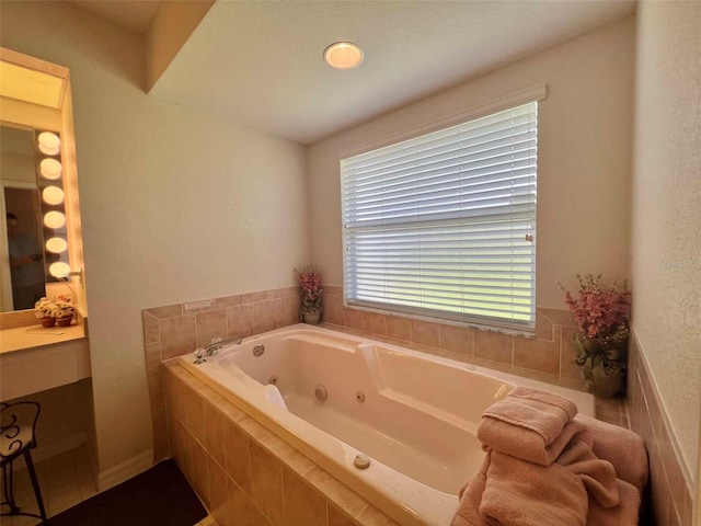 bathroom featuring a whirlpool tub and vanity