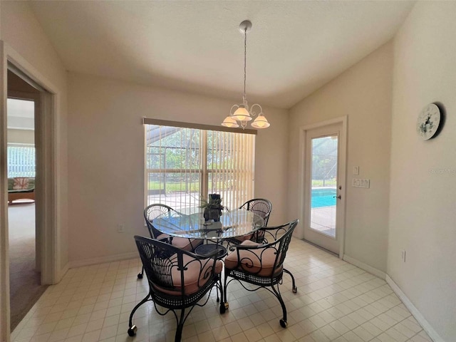dining room with a notable chandelier, baseboards, vaulted ceiling, and a wealth of natural light