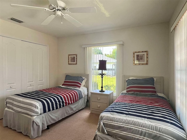 bedroom featuring visible vents, a closet, ceiling fan, and carpet flooring