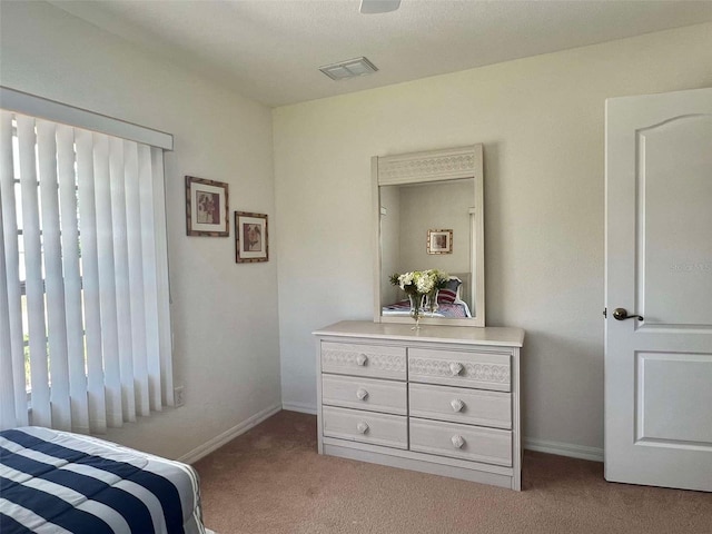 carpeted bedroom featuring baseboards and visible vents