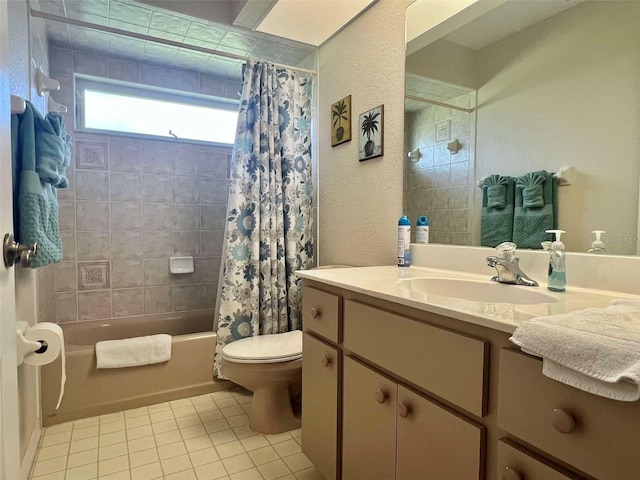 bathroom with toilet, vanity, tile patterned flooring, shower / bath combo with shower curtain, and a textured wall