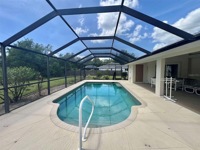 outdoor pool featuring fence, a lanai, and a patio area