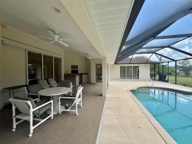 outdoor pool featuring a lanai, a patio, and a ceiling fan