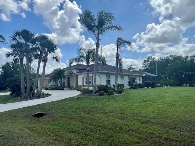 ranch-style house with a front yard, driveway, and stucco siding