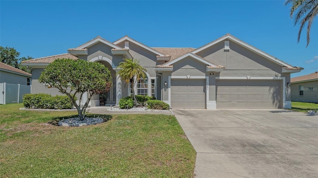 1085 Mallard Marsh Dr, Osprey, FL 34229 - ranch-style home with concrete driveway, an attached garage, and a front yard
