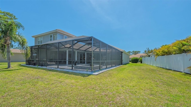 1085 Mallard Marsh Dr, Osprey, FL 34229 - rear view of house featuring glass enclosure, a yard, and fence