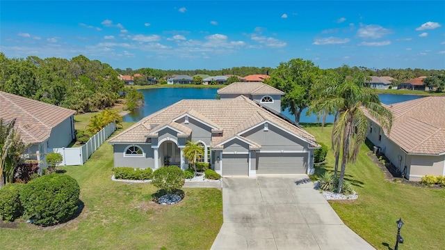 1085 Mallard Marsh Dr, Osprey, FL 34229 - view of front of house with a garage, driveway, a water view, fence, and a front yard
