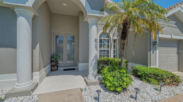 1085 Mallard Marsh Dr, Osprey, FL 34229 - doorway to property featuring an attached garage, french doors, and stucco siding