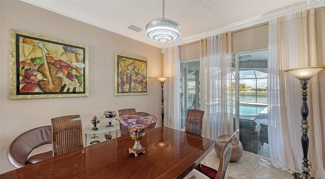1085 Mallard Marsh Dr, Osprey, FL 34229 - dining area with visible vents, a chandelier, and crown molding