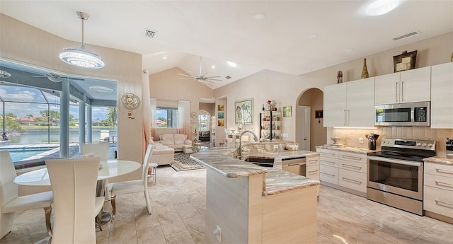 1085 Mallard Marsh Dr, Osprey, FL 34229 - kitchen featuring lofted ceiling, appliances with stainless steel finishes, a sink, and visible vents