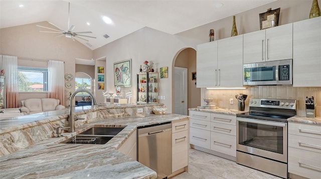 1085 Mallard Marsh Dr, Osprey, FL 34229 - kitchen featuring a sink, open floor plan, ceiling fan, arched walkways, and stainless steel appliances