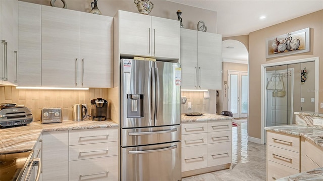 1085 Mallard Marsh Dr, Osprey, FL 34229 - kitchen featuring recessed lighting, stainless steel fridge with ice dispenser, backsplash, electric stove, and arched walkways