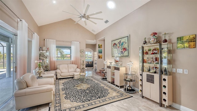 1085 Mallard Marsh Dr, Osprey, FL 34229 - living area with arched walkways, baseboards, visible vents, ceiling fan, and high vaulted ceiling