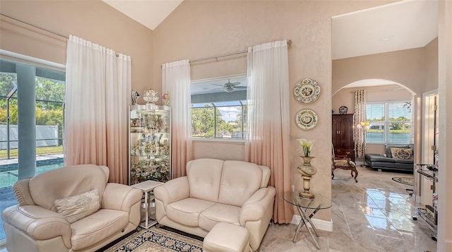 1085 Mallard Marsh Dr, Osprey, FL 34229 - sitting room featuring marble finish floor, arched walkways, a healthy amount of sunlight, and vaulted ceiling