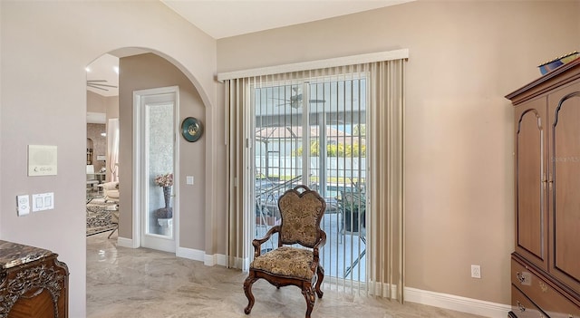 1085 Mallard Marsh Dr, Osprey, FL 34229 - foyer with ceiling fan, arched walkways, marble finish floor, and baseboards