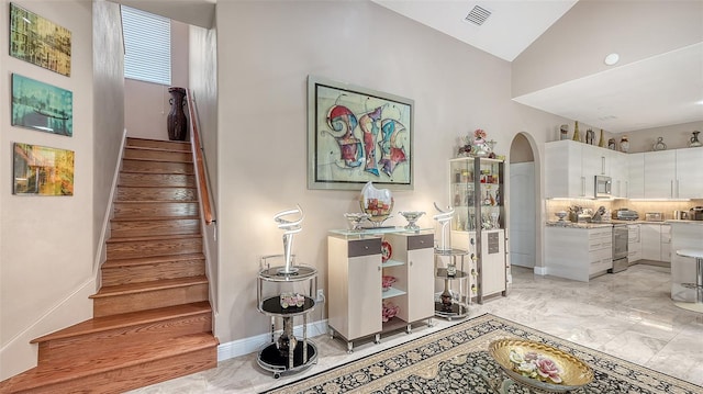 1085 Mallard Marsh Dr, Osprey, FL 34229 - stairs with marble finish floor, arched walkways, vaulted ceiling, and visible vents