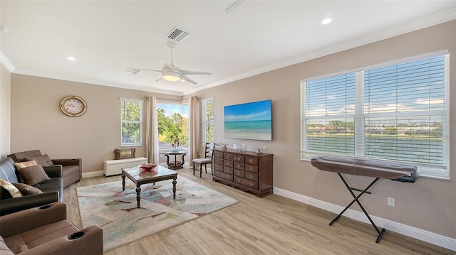 1085 Mallard Marsh Dr, Osprey, FL 34229 - living room with a ceiling fan, light wood-style flooring, baseboards, ornamental molding, and visible vents