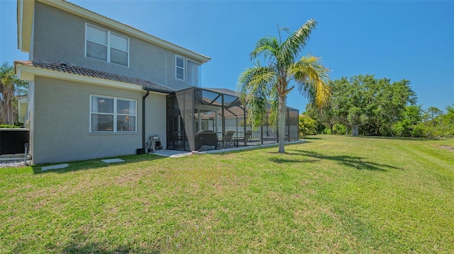 1085 Mallard Marsh Dr, Osprey, FL 34229 - rear view of house with stucco siding, a tile roof, a yard, and glass enclosure
