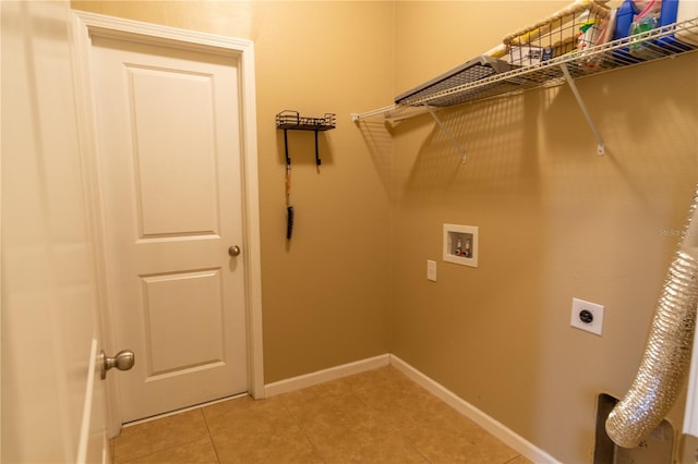 laundry area featuring light tile patterned flooring, hookup for a washing machine, baseboards, laundry area, and hookup for an electric dryer