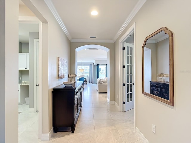 13724 Quinta St, Venice, FL 34293 - hall featuring crown molding, visible vents, baseboards, arched walkways, and light tile patterned floors
