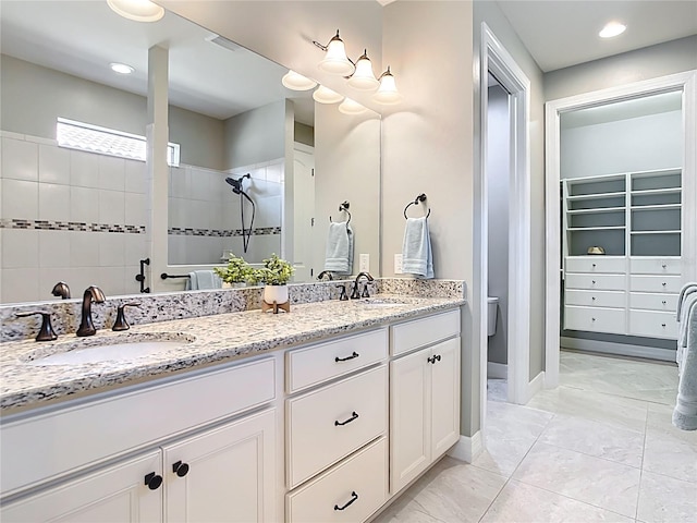 13724 Quinta St, Venice, FL 34293 - full bathroom featuring double vanity, a walk in shower, a walk in closet, and a sink