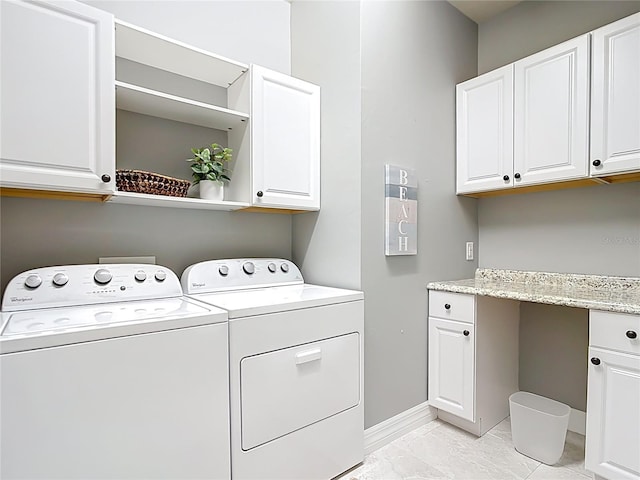 13724 Quinta St, Venice, FL 34293 - washroom with cabinet space, washer and clothes dryer, marble finish floor, and baseboards