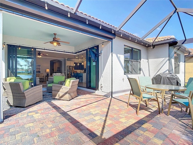 13724 Quinta St, Venice, FL 34293 - view of patio featuring glass enclosure, ceiling fan, and outdoor dining area