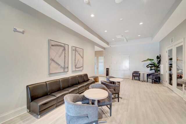 15719 Barefoot Beach Dr, Lakewood Ranch, FL 34211 - living area with light wood-type flooring, french doors, recessed lighting, and a tray ceiling