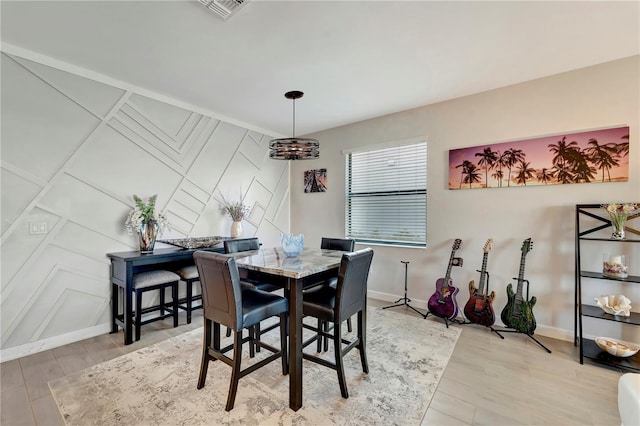 15719 Barefoot Beach Dr, Lakewood Ranch, FL 34211 - dining room with light wood-style flooring and a decorative wall