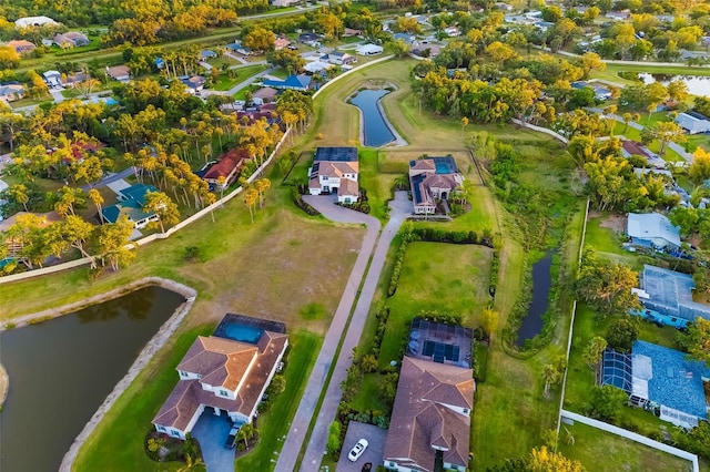 drone / aerial view featuring a water view and a residential view
