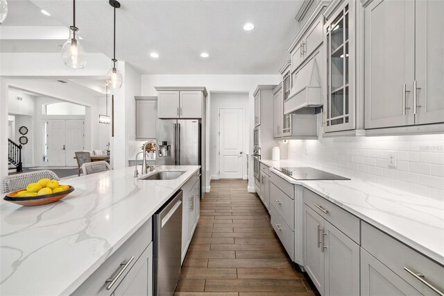4712 Margutta Ct, Sarasota, FL 34240 - kitchen featuring stainless steel appliances, a sink, gray cabinets, dark wood-style floors, and recessed lighting