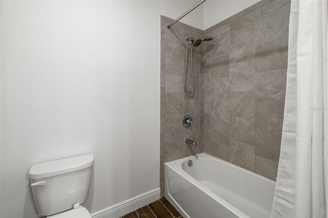 4712 Margutta Ct, Sarasota, FL 34240 - bathroom with toilet, shower / tub combo, baseboards, and wood finished floors
