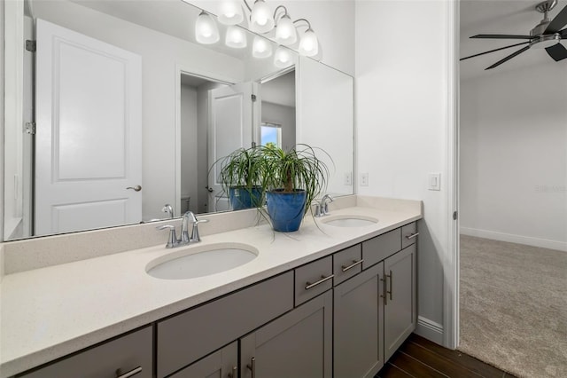 4712 Margutta Ct, Sarasota, FL 34240 - full bath featuring a ceiling fan, double vanity, toilet, and baseboards