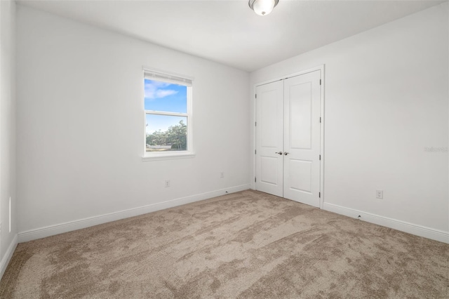 4712 Margutta Ct, Sarasota, FL 34240 - unfurnished bedroom featuring carpet floors, baseboards, and a closet