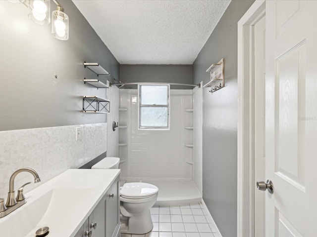 bathroom featuring toilet, a textured ceiling, a shower stall, vanity, and tile patterned flooring