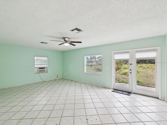 unfurnished room with cooling unit, ceiling fan, visible vents, and a wealth of natural light