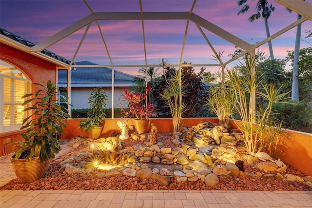 view of patio / terrace featuring a lanai