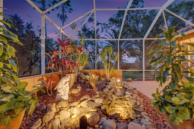 view of patio featuring glass enclosure