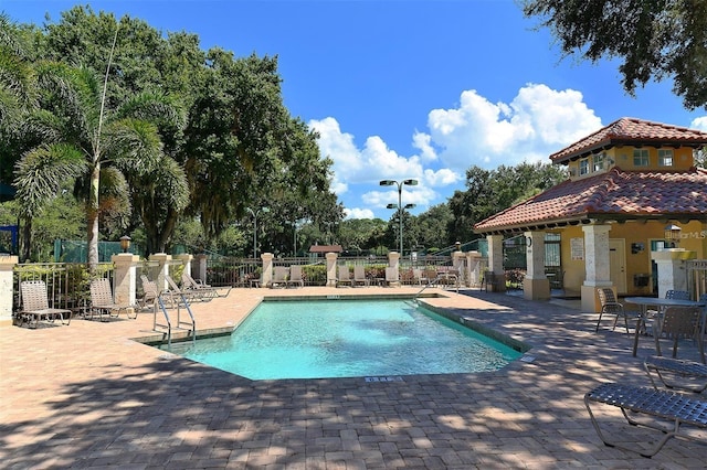 pool featuring a patio and fence