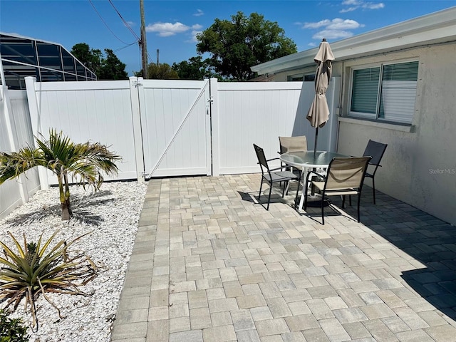 2605 Sunnybrook Dr, Sarasota, FL 34239 - view of patio / terrace with outdoor dining area, a gate, and a fenced backyard