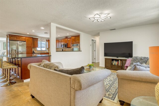 2605 Sunnybrook Dr, Sarasota, FL 34239 - living room featuring recessed lighting, a textured ceiling, visible vents, and light tile patterned floors